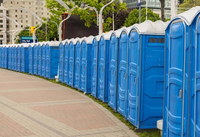 a row of portable restrooms at an outdoor special event, ready for use in Roselawn IN